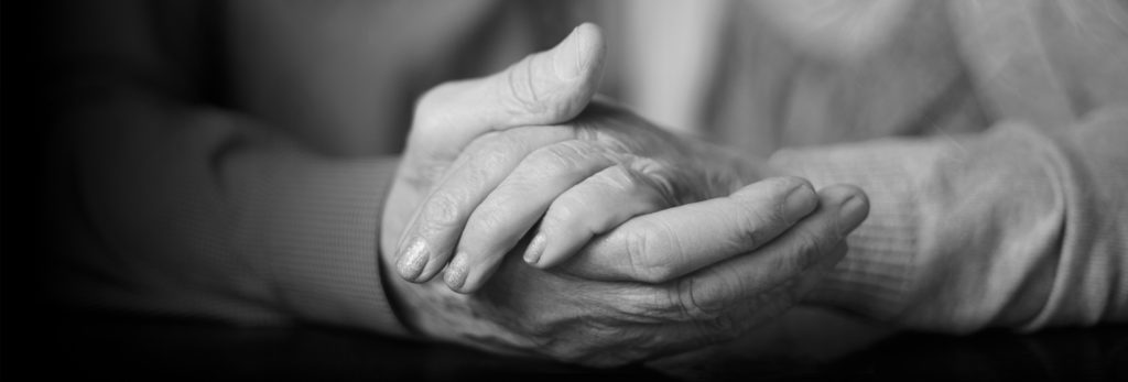 Elderly hands holding each other.