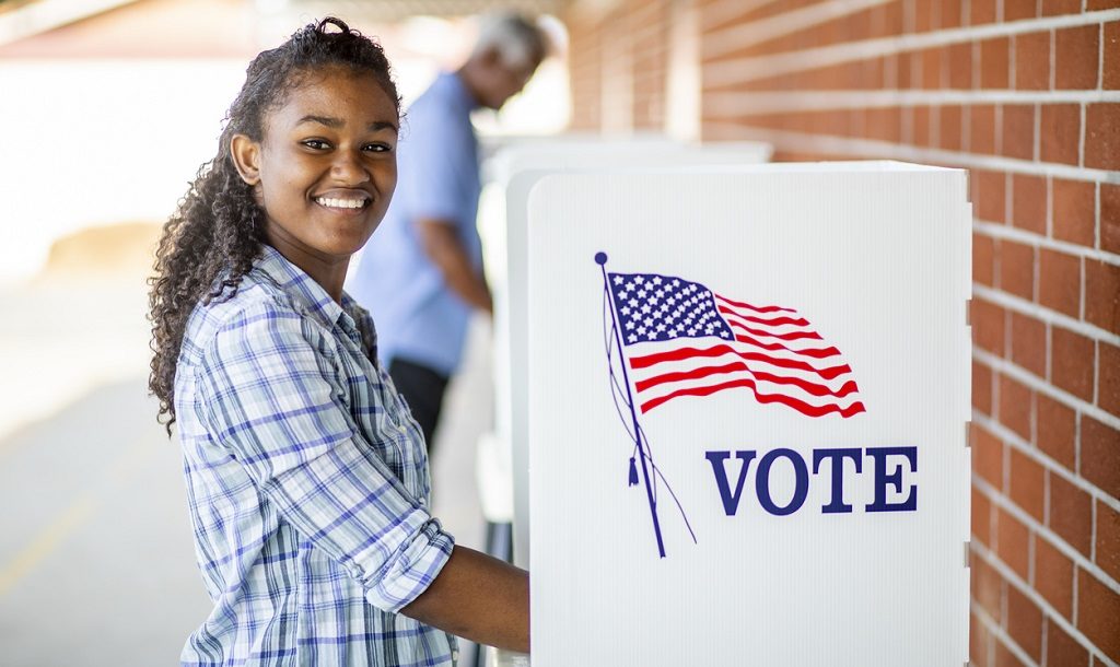 A young black girl voting on election day